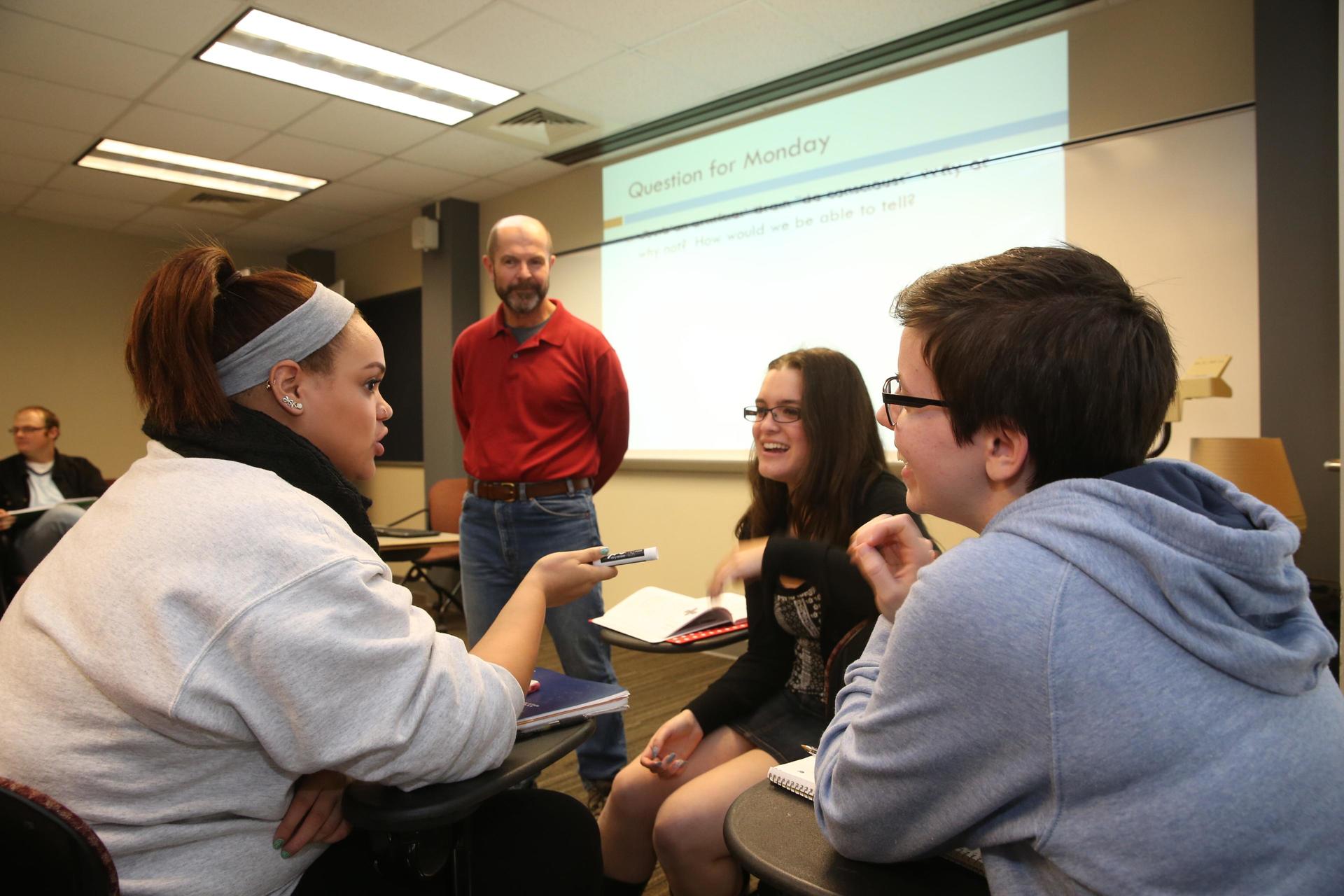 philosophy professor with students in classroom