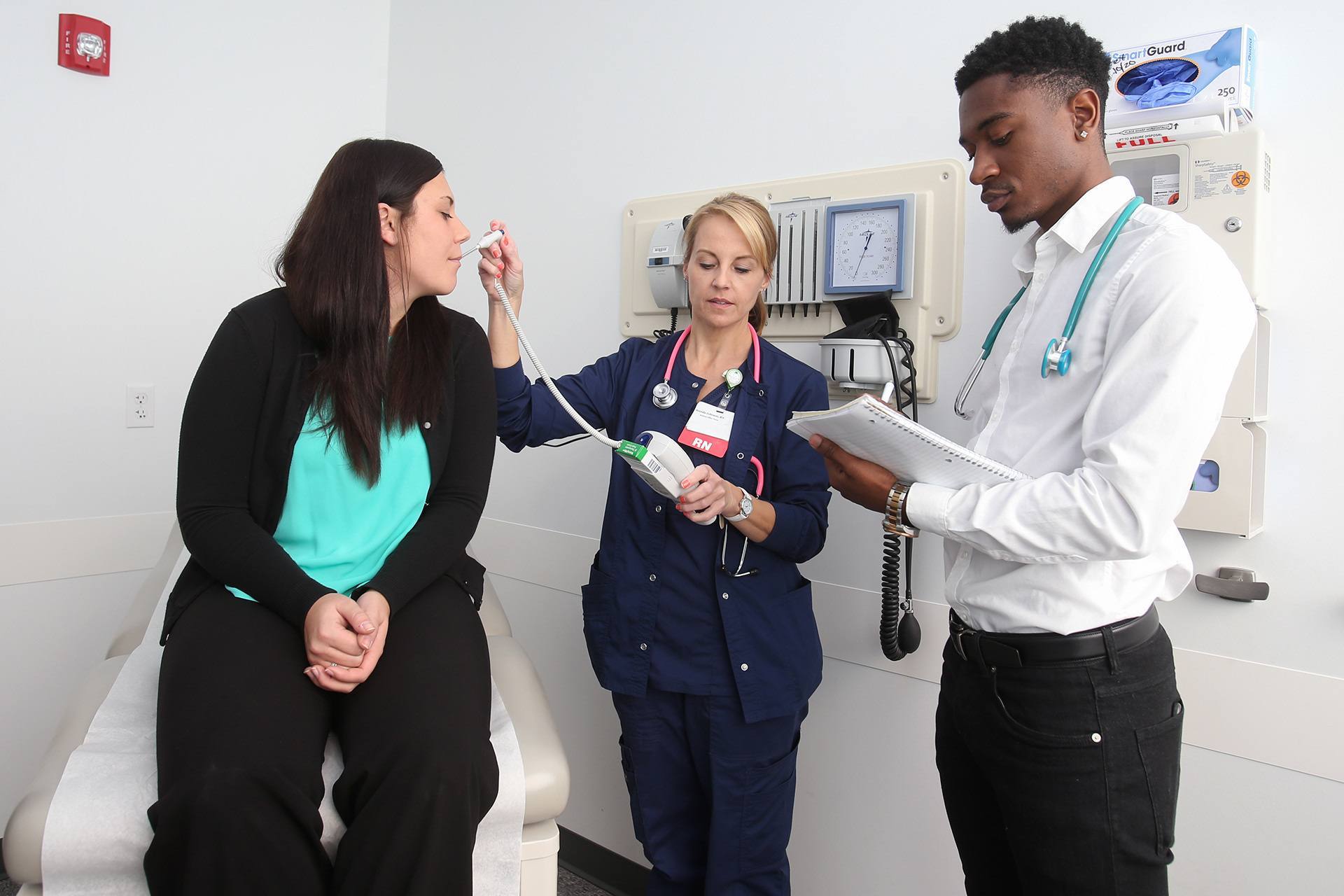 Applied health science students learn to take a temperature in a modern healthcare simulation lab.