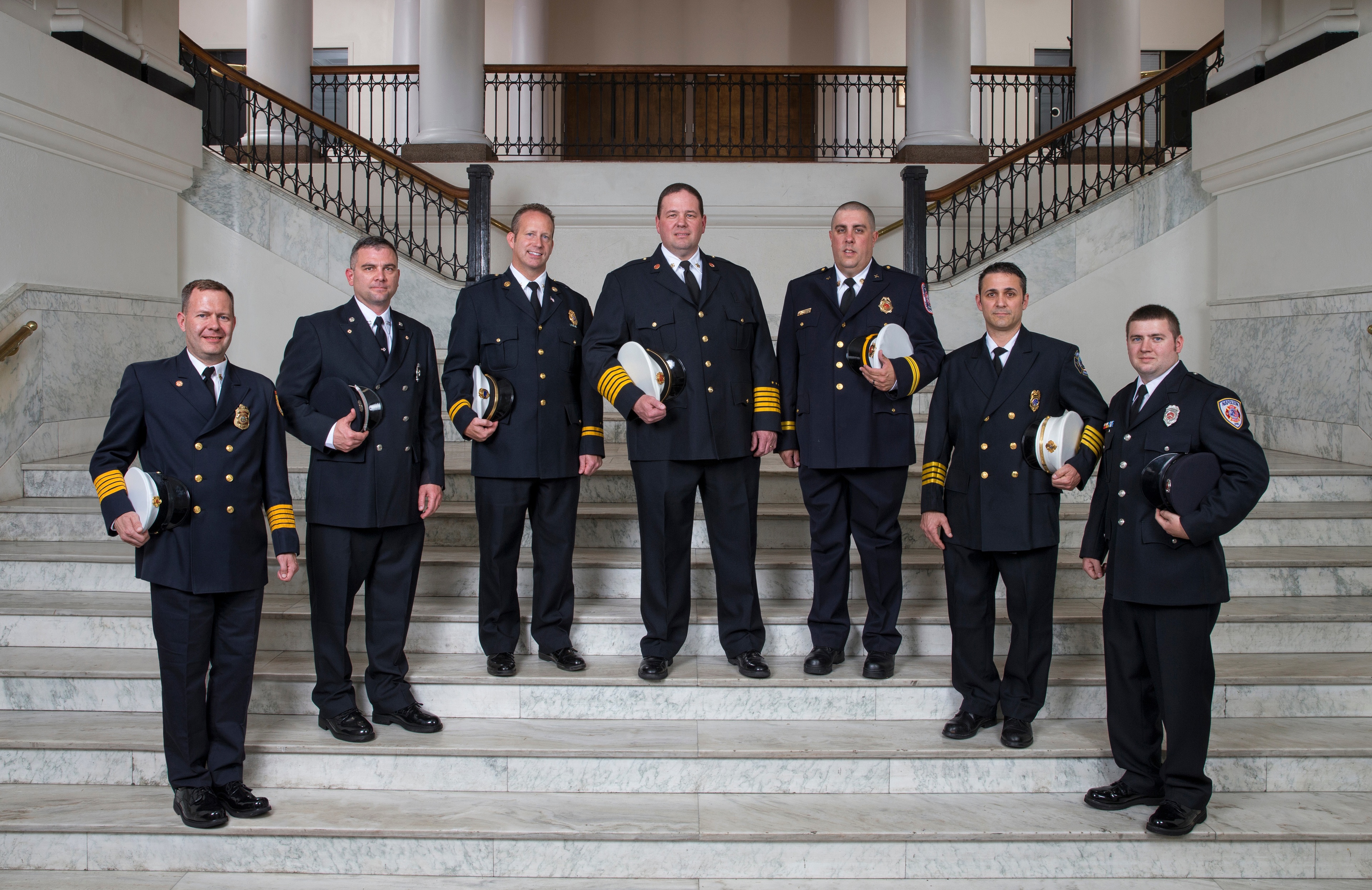 A group of fire administration stand in University Hall 