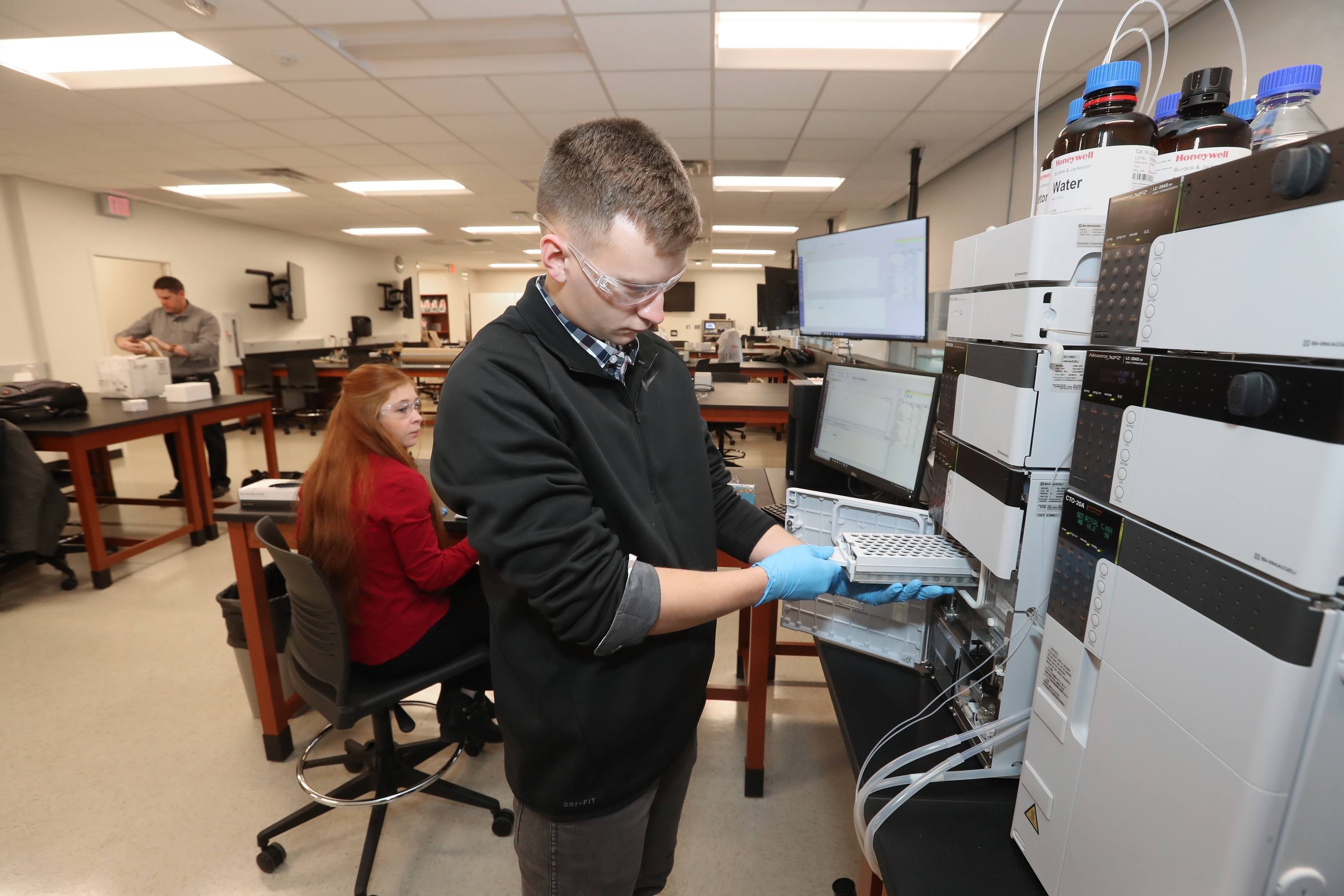 BGSU Forensic Science student examines forensic evidence in a mock crime scene house.