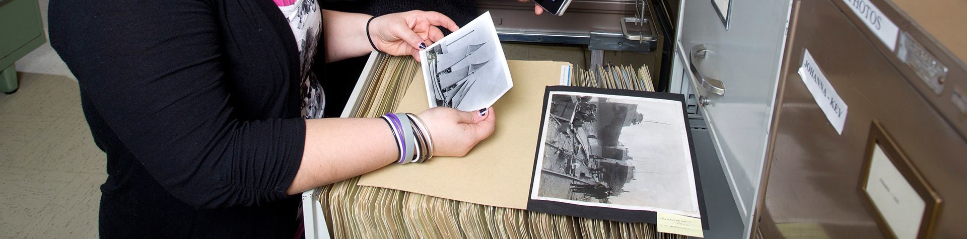 A History professor and a student look at a picture. 