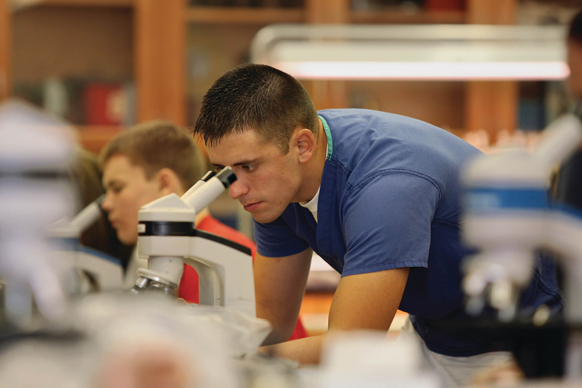 Student looking through a microscope