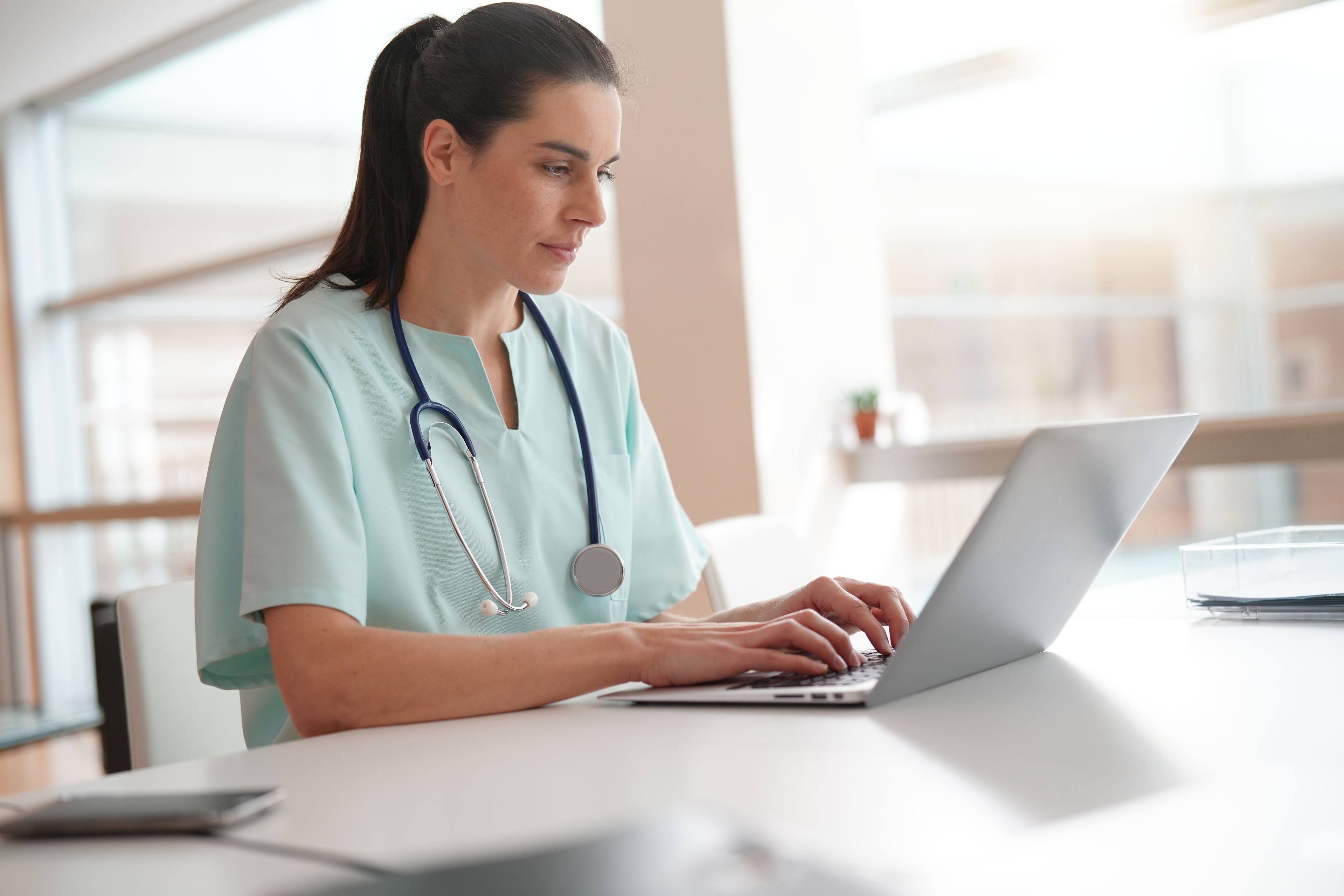 Nurse working on laptop computer