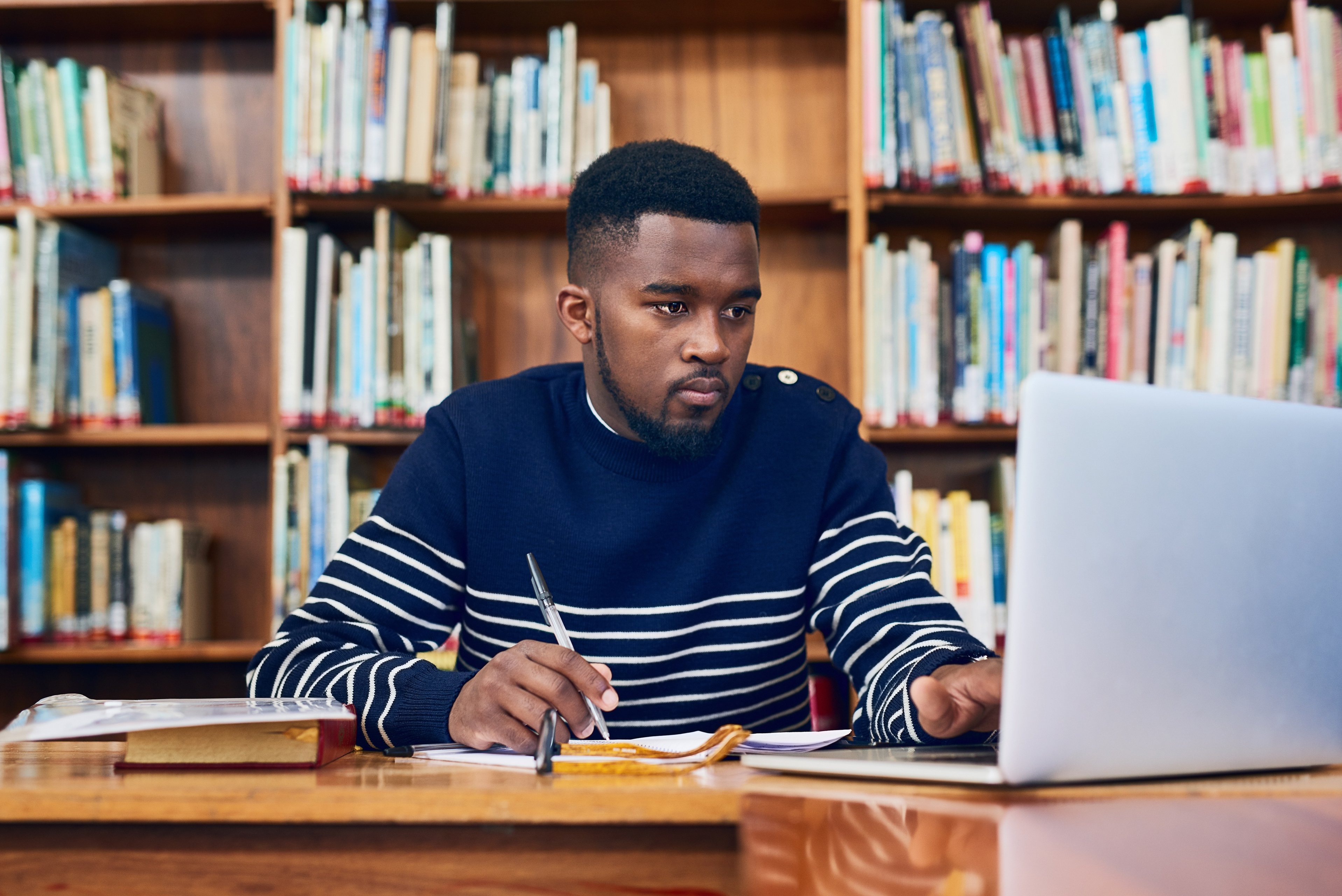 Library, laptop and university student