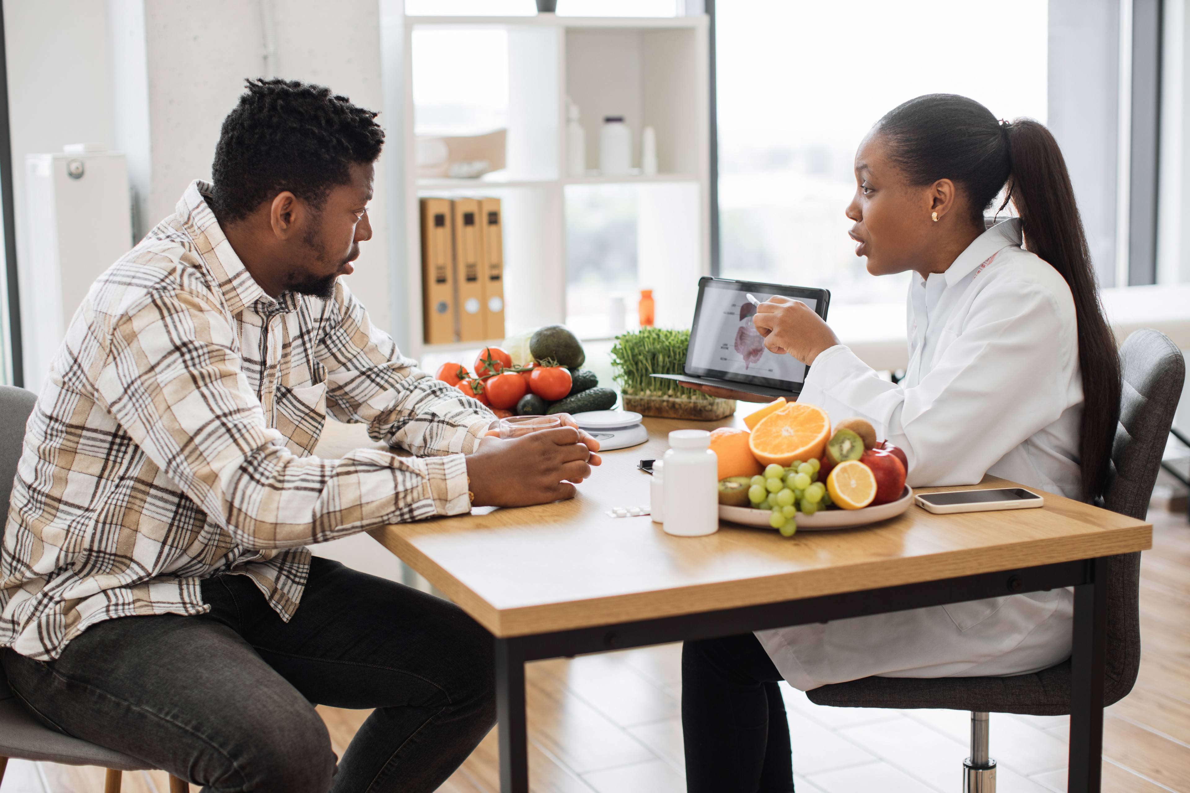 Woman holding tablet with GI tract while counseling client