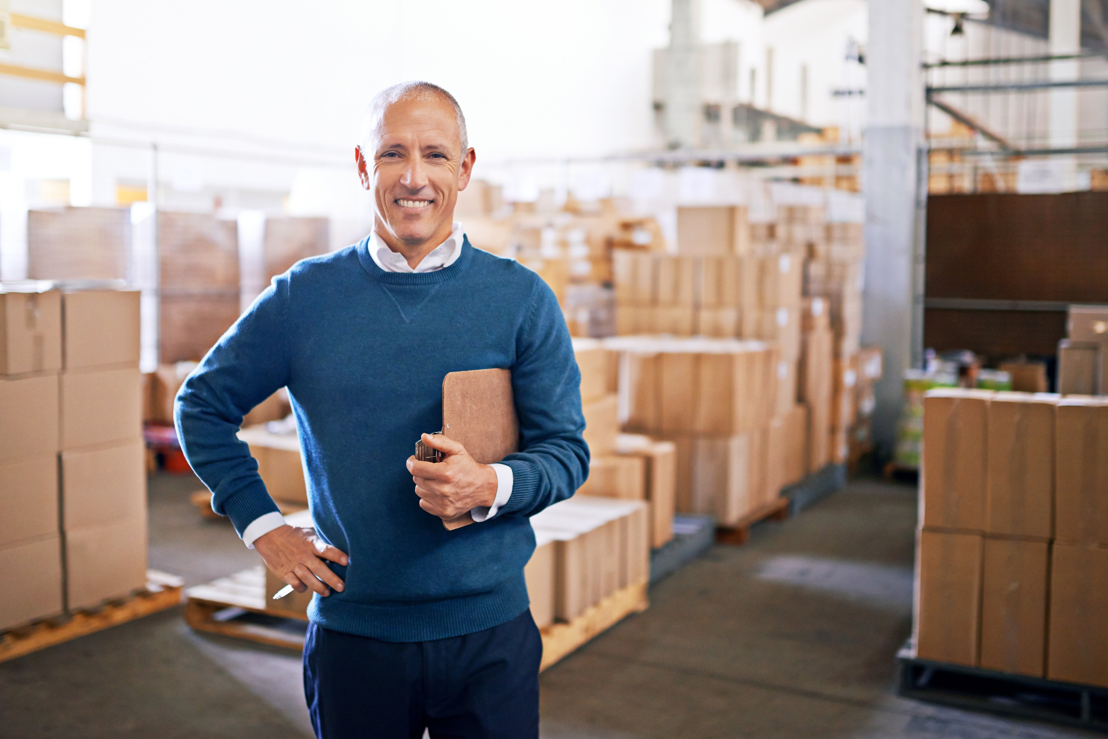 Checklist, happy and portrait of man in warehouse for cargo, storage and shipping. Distribution, ecommerce and logistics with employee in factory plant for supply chain, package or wholesale supplier