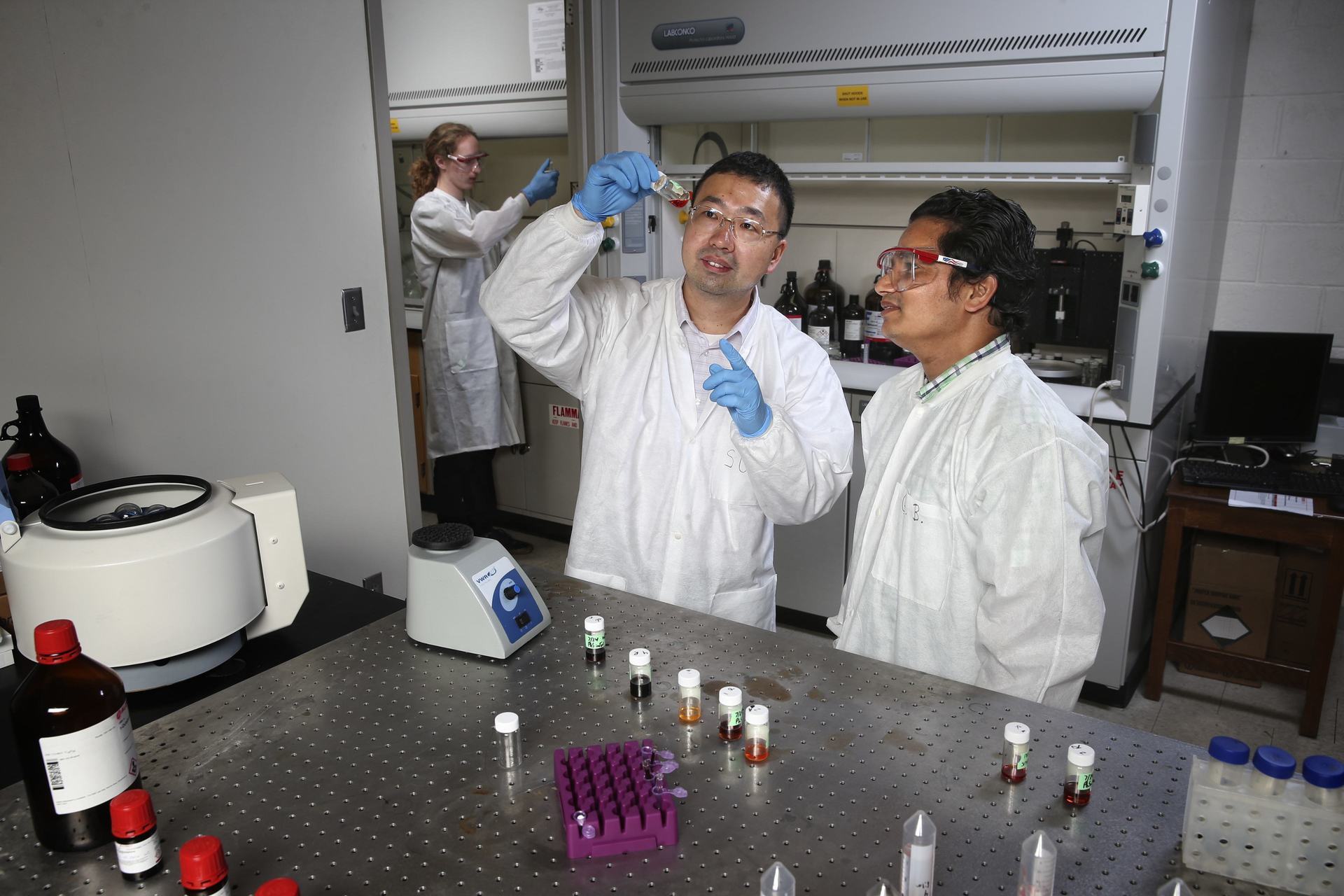 professor and students in physics lab