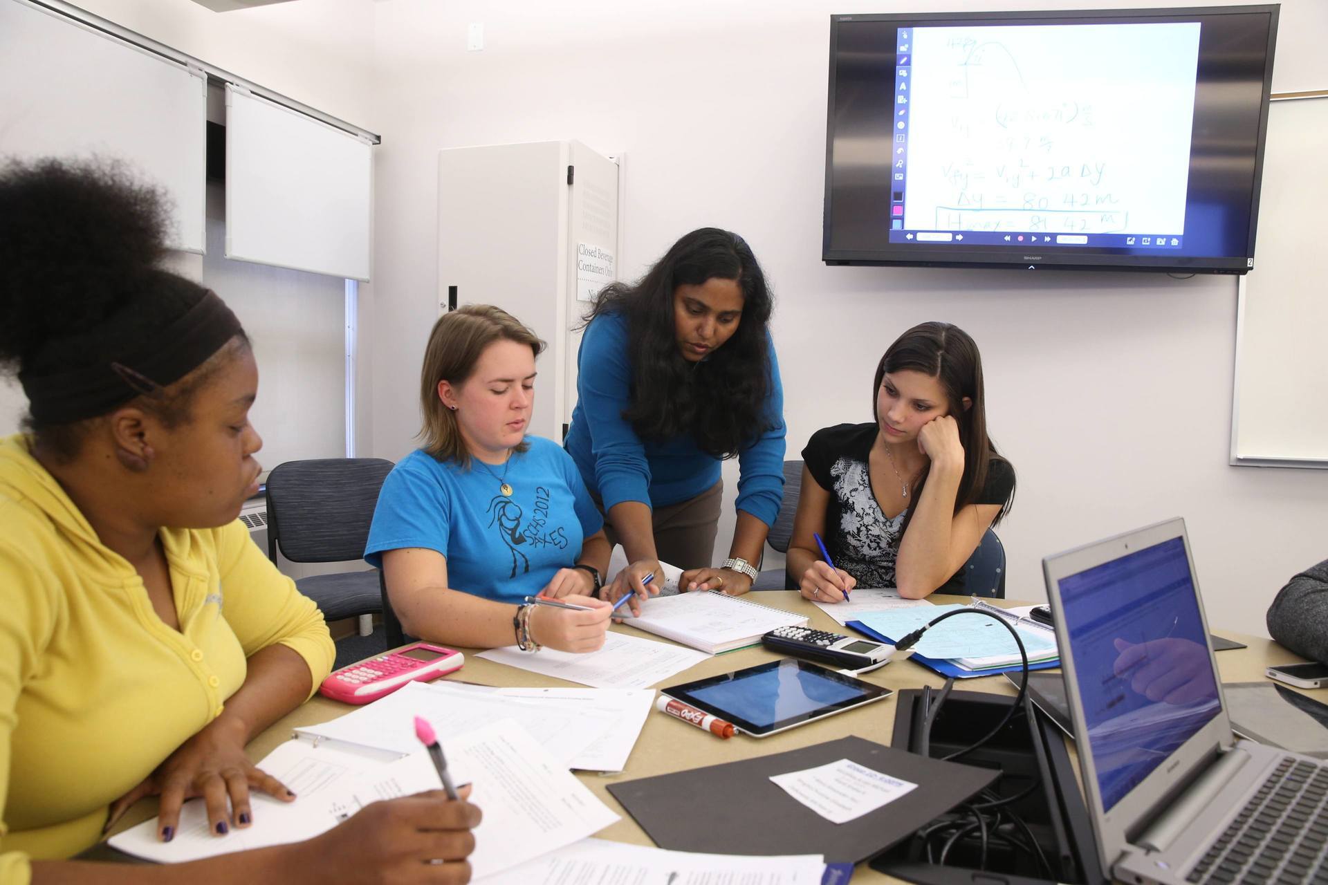 physics professor and students in classroom