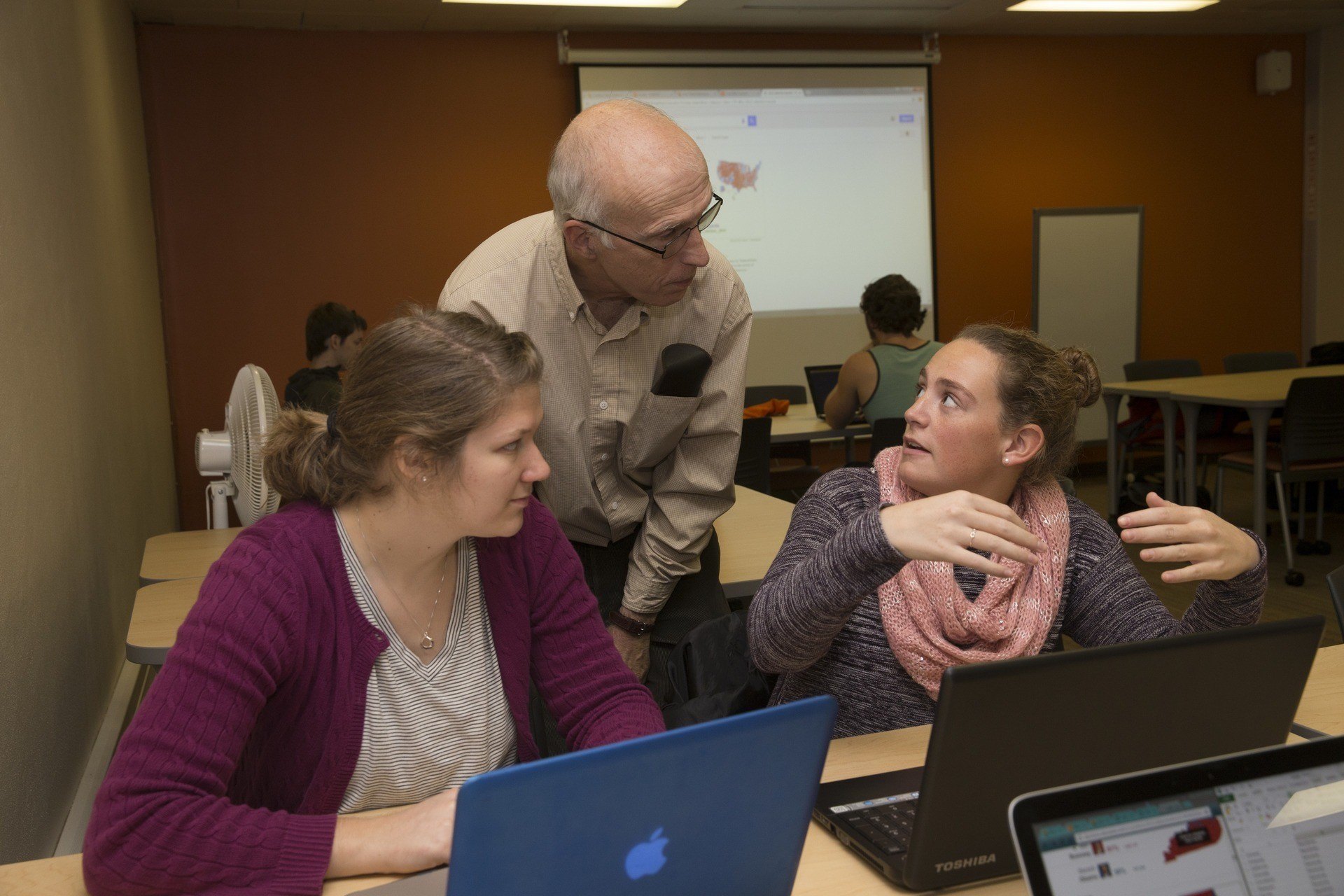 statistics professor with students in classroom