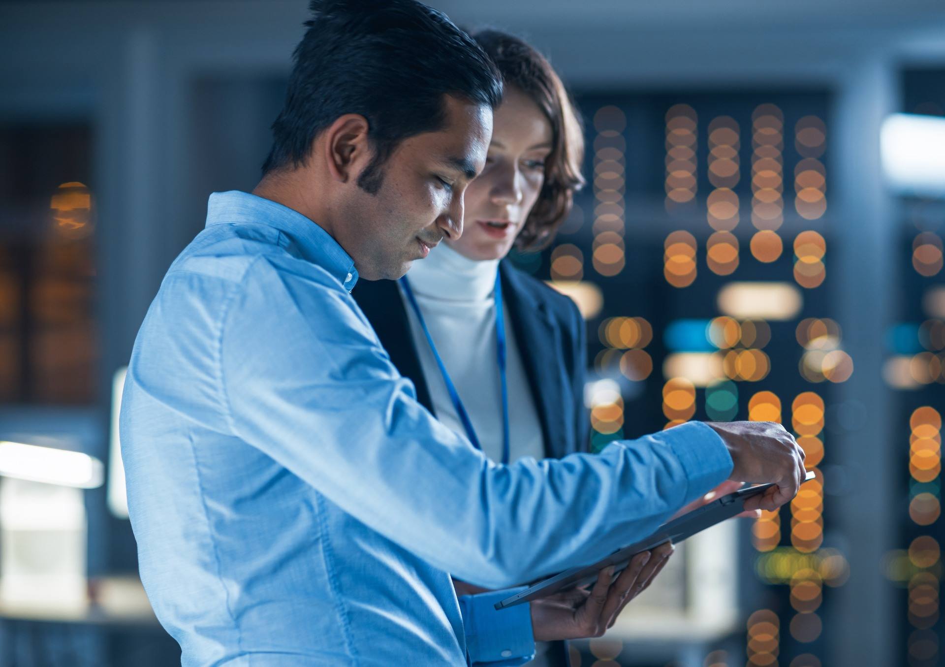 Man and woman are looking at a tablet in a lab