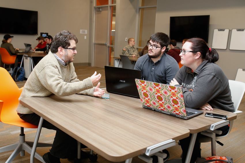 A history professor talks to two history students.