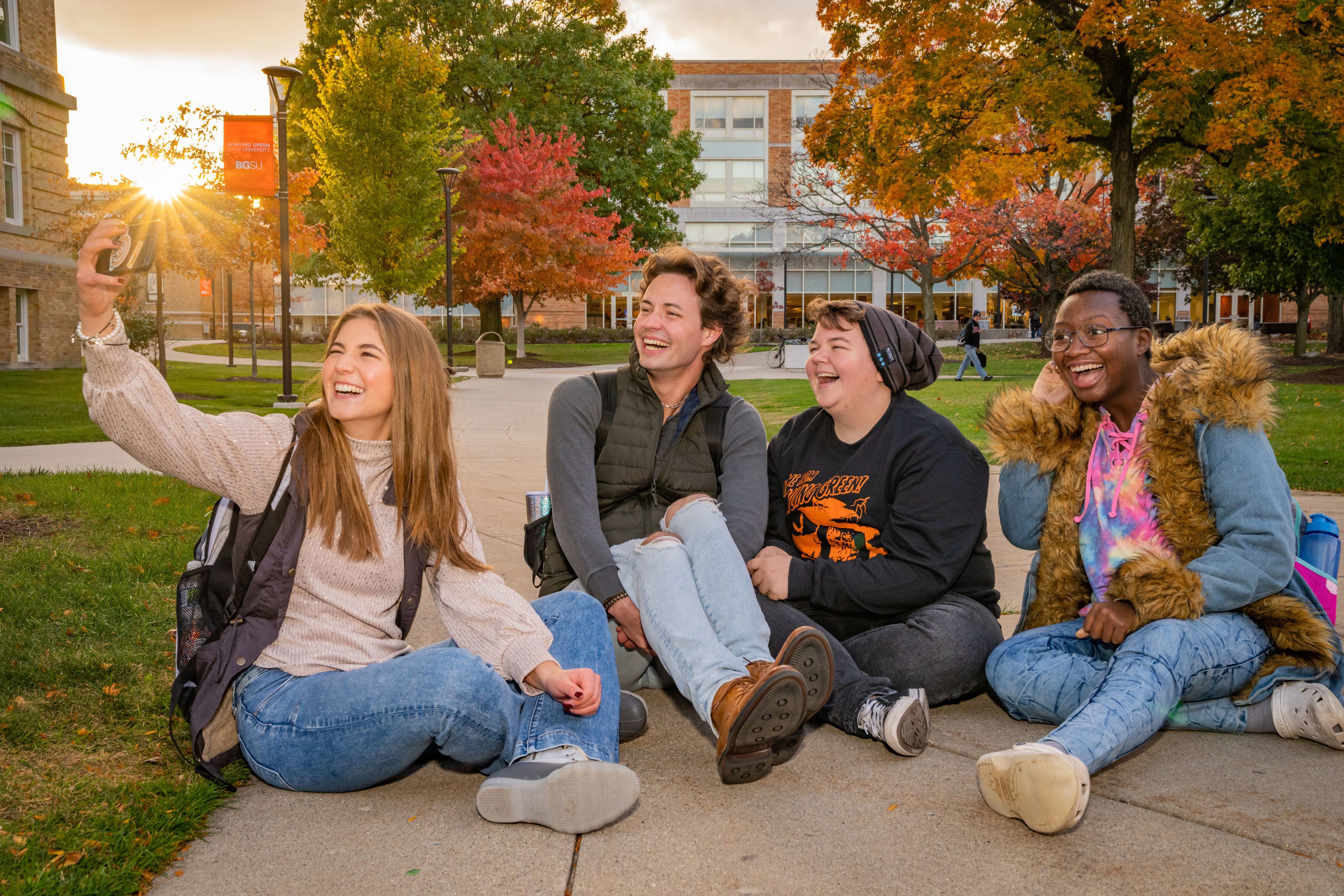 Two students taking a selfie outside