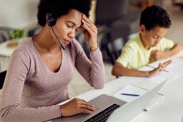 photo of mother and son working and studying at home