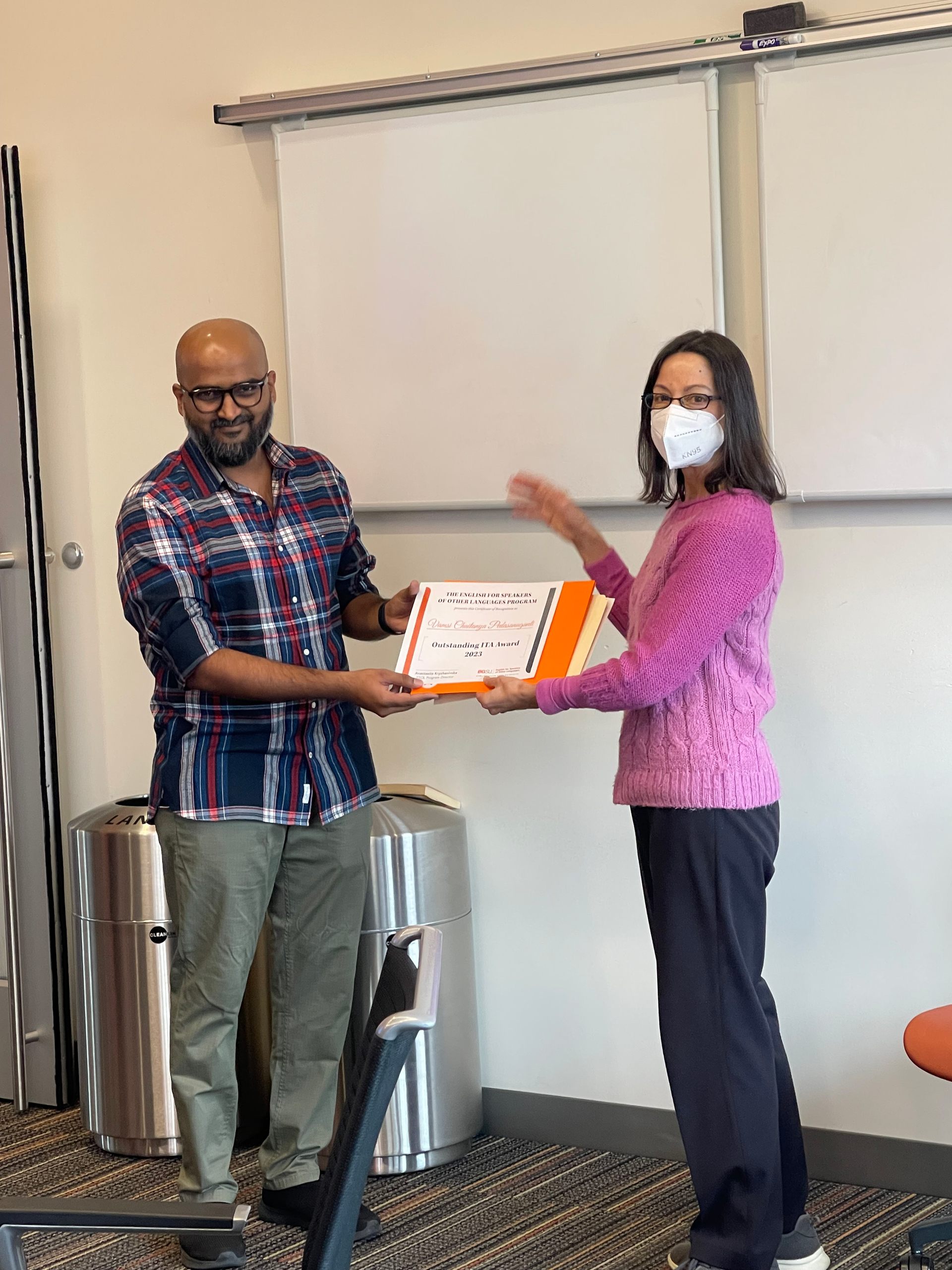 Vamsi receiving the Outstanding ITA Certificate from Dr. Fernanda Capraro, T/ESOL Program faculty member. 