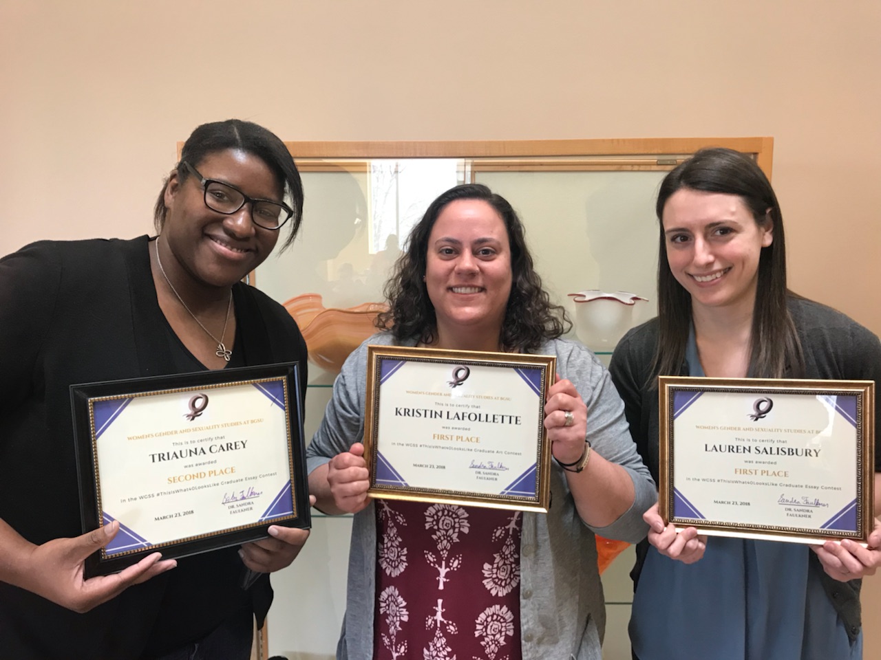 Triauna Carey, Lauren Salisbury, and Kristin LaFollete hold their awards