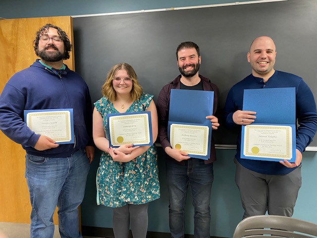 Group of people holding teaching awards 