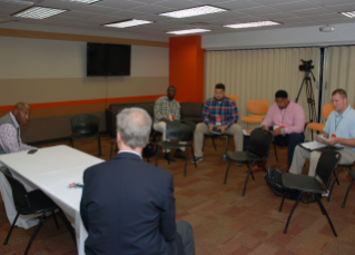 Bucky Brooks of NFL.com and Malcolm Moran help boot camp participants prepare for a mock press conference with BGSU football Head Coach Dino Babers.