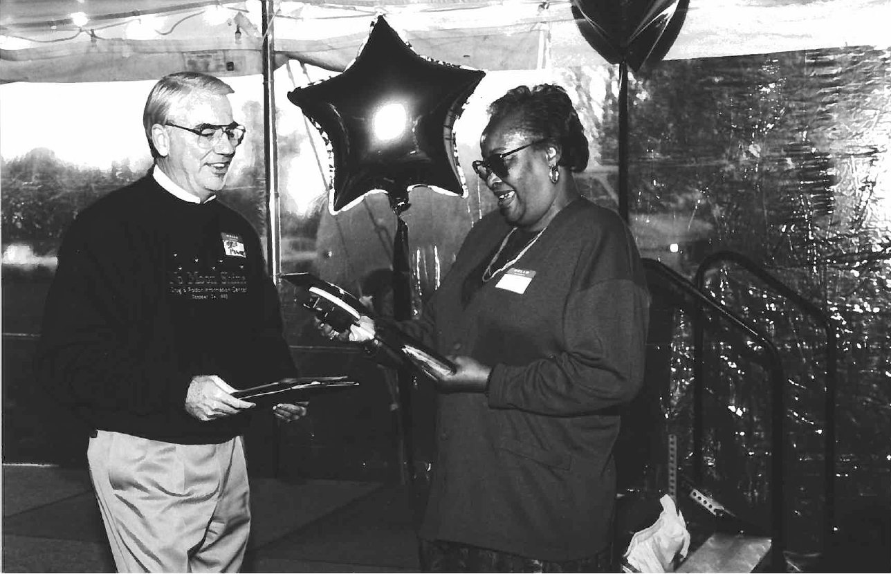 Helen Rankin smiling and speaking with another person