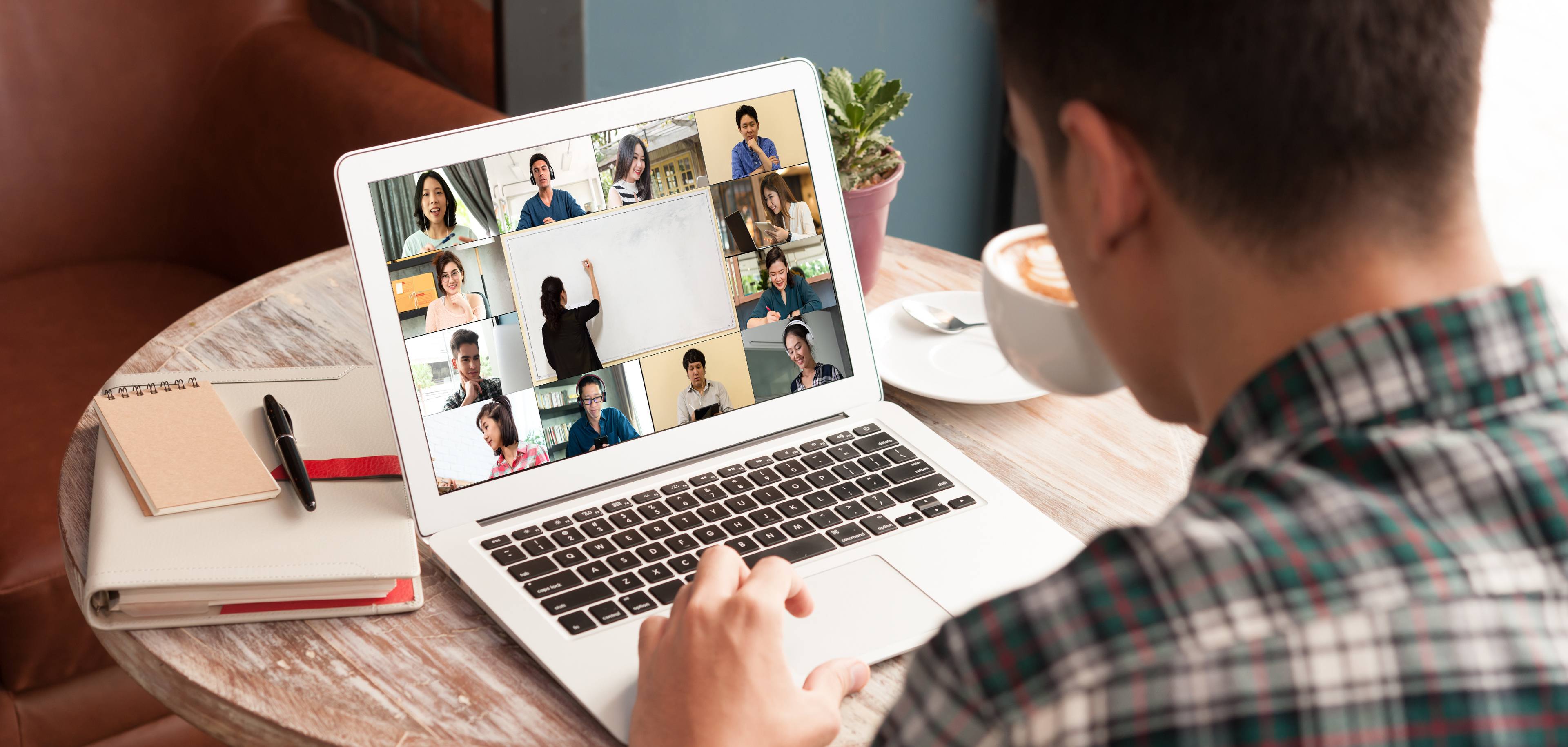 Man use computer laptop with screen of video conference of course online attended by people from many places