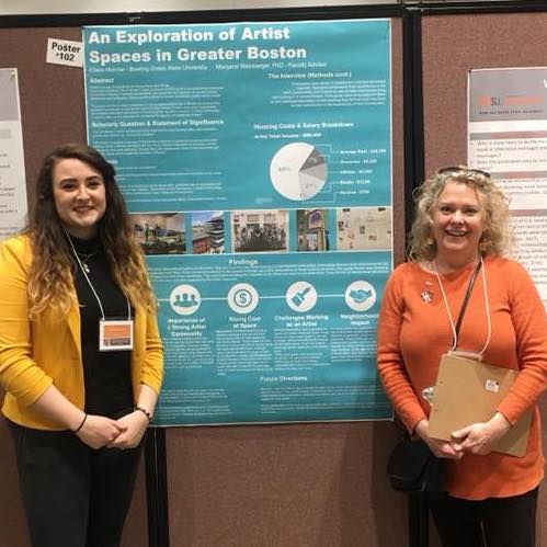 Dr. Margaret Weinberger (right) stands with undergraduate student during research poster conference