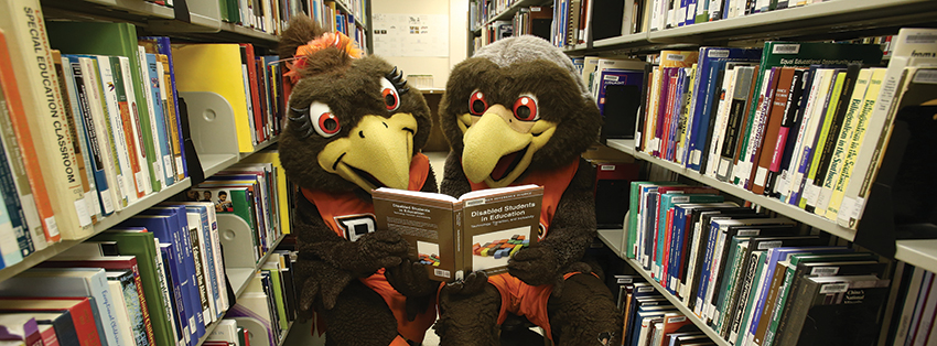 Freddie and Frieda reading a book together in the library