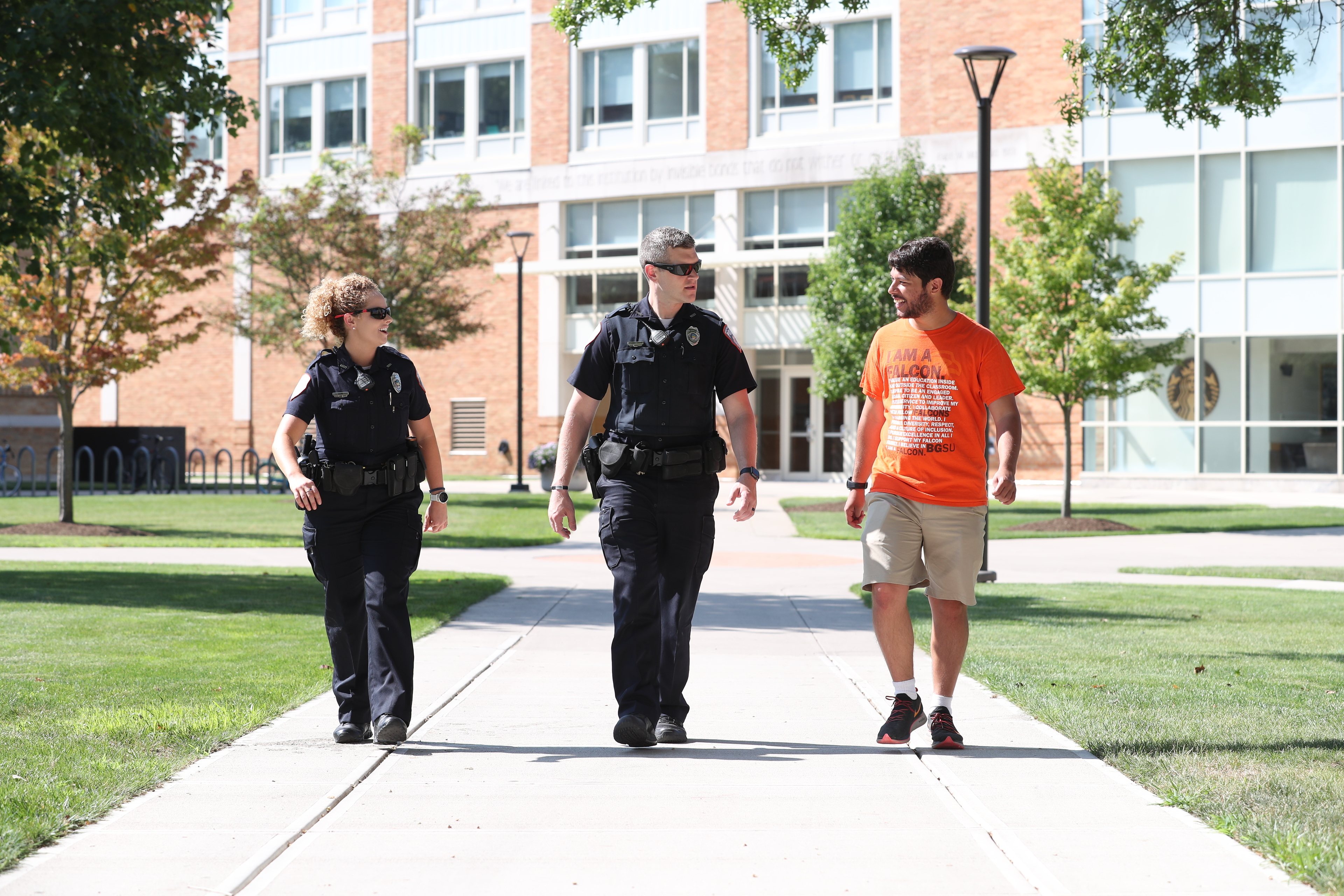 cops-and-student-walking-together-on-campus-