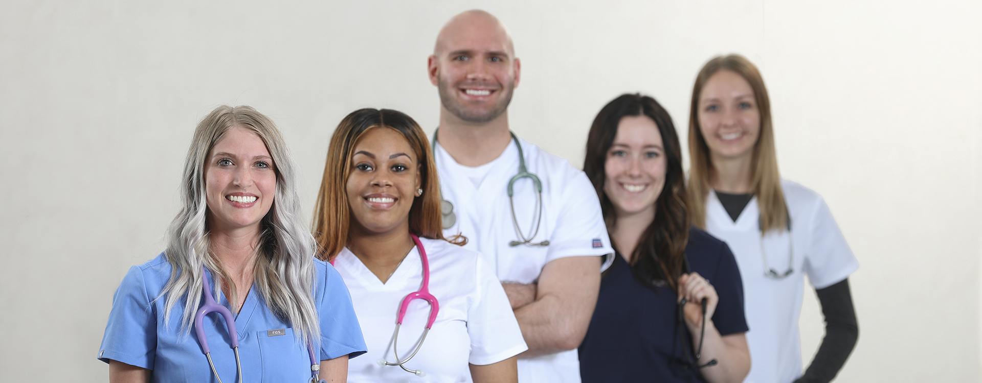 smiling nurses standing in a line