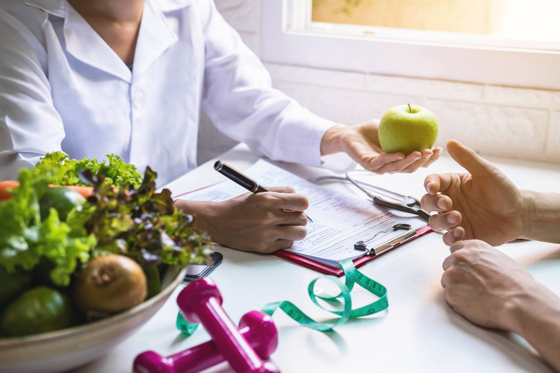 Nutritionist giving consultation to patient with healthy fruit and vegetable, Right nutrition and diet concept