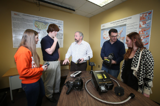 Dr. Steve Lab, professor and director of the Criminal Justice Program (center), and John Liederbach, associate professor of Criminal Justice, examine equipment donated by the Ohio Bureau of Criminal Investigation (BCI) as they prepare students for successful careers with a 480-hour internship requirement that’s double what most programs require.