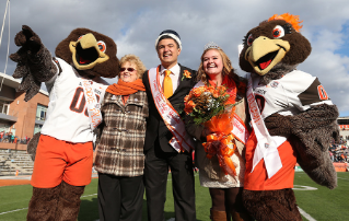 President Mary Ellen Mazey with Homecoming King Austin Flores and Queen Maren Legg.