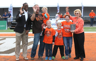 Melanie Yarger, her husband Curt, and children Hannah, 9, Nicholas, 8, and Natalie, 5 were chosen as the 2015 Falcon Family of the Year. The honor was presented to them at the Sept. 19 home football game, during Falcon Family Weekend by President Mary Ellen Mazey, right, and Sidney Childs, Interim Vice President for Student Affairs,left.