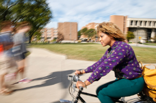 Senior Marjorie Williams bikes across campus between business classes.