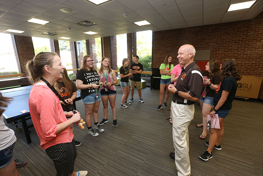 Science and Math Education in ACTION director Daniel Brahier (right) shares a laugh with freshman Brooke Davis (left, in pink)