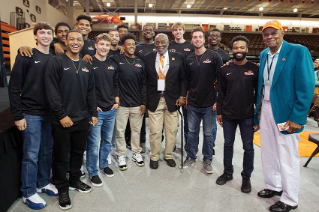 Hall of Famers Chuck McCampbell ’59 and Crystal Ellis ’57, ’75, ’93 with current Men’s Basketball team members