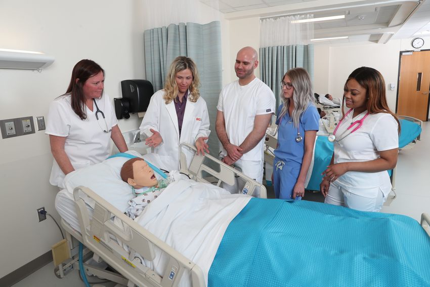 medical students with patient dummy