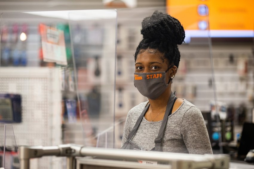 Student in staff mask on campus