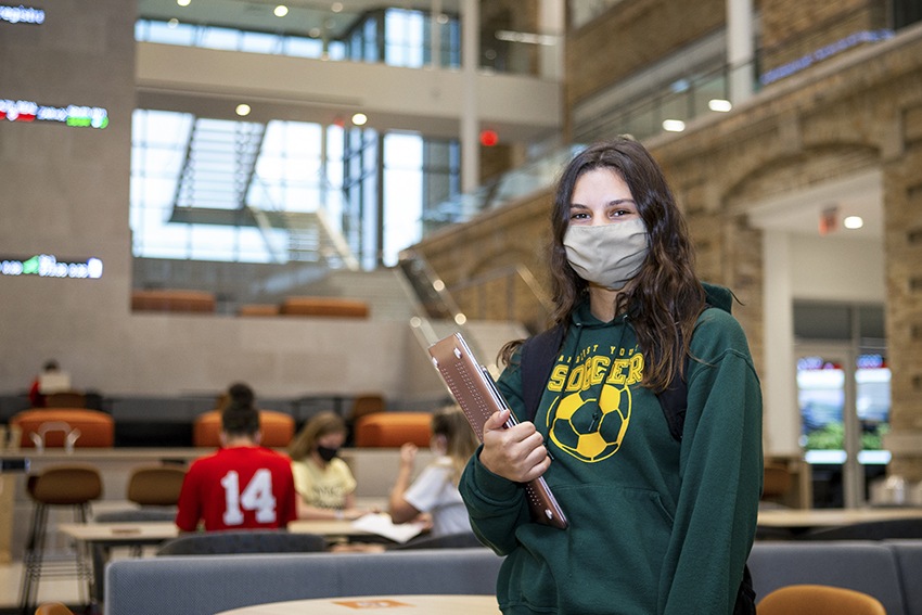 Female student standing in Maurer lobby