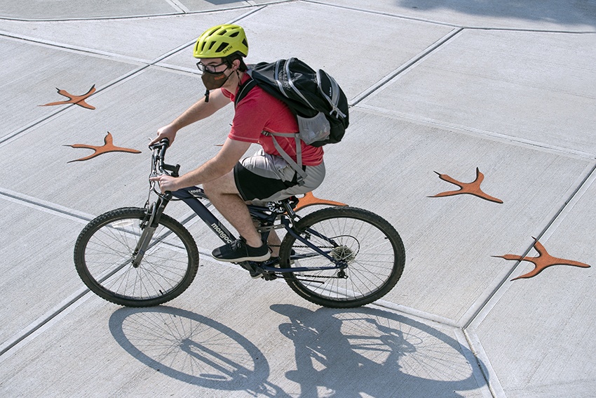 student biking across campus