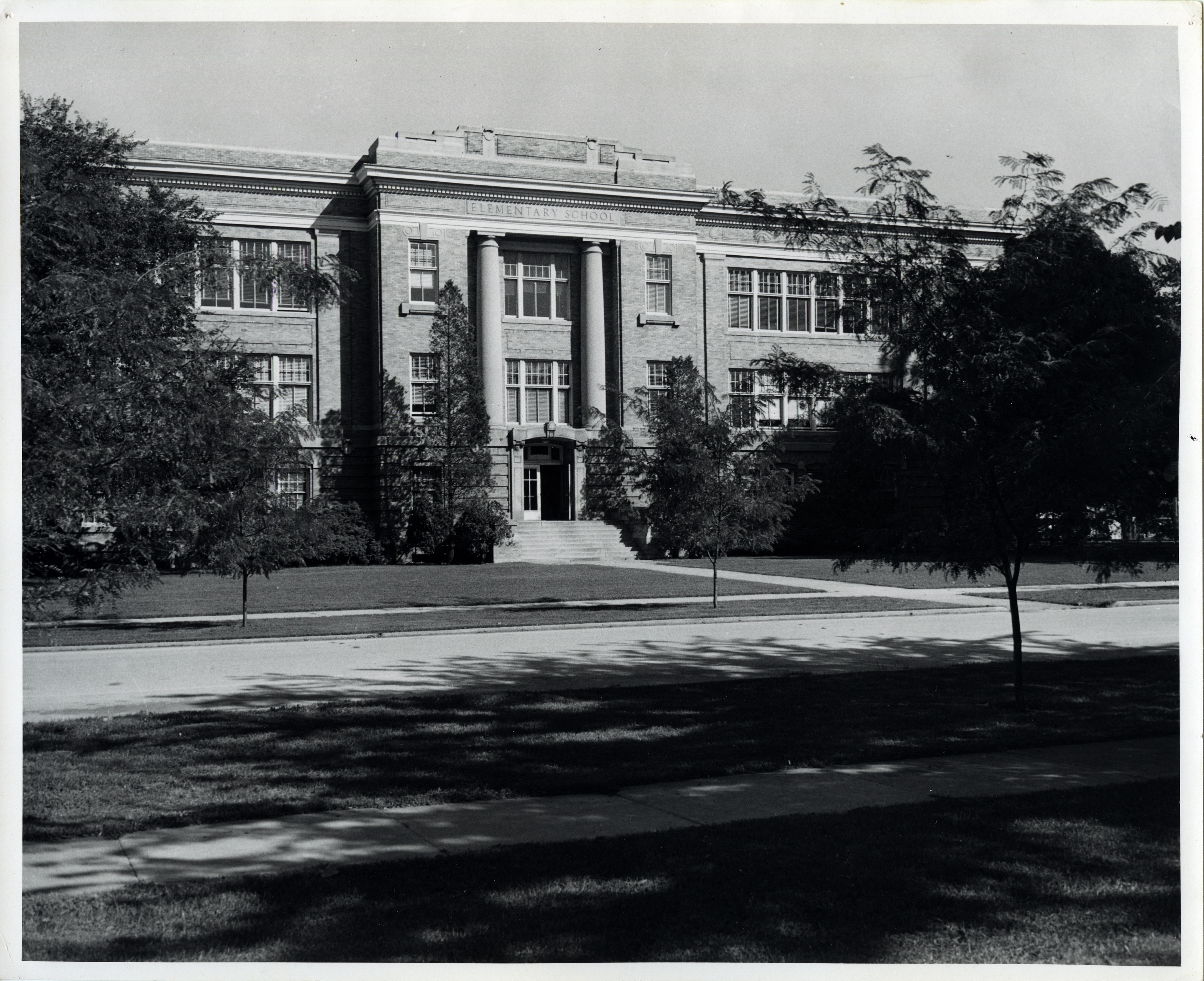 Iconic campus photo of the Elementary School along the once tree-lined street.