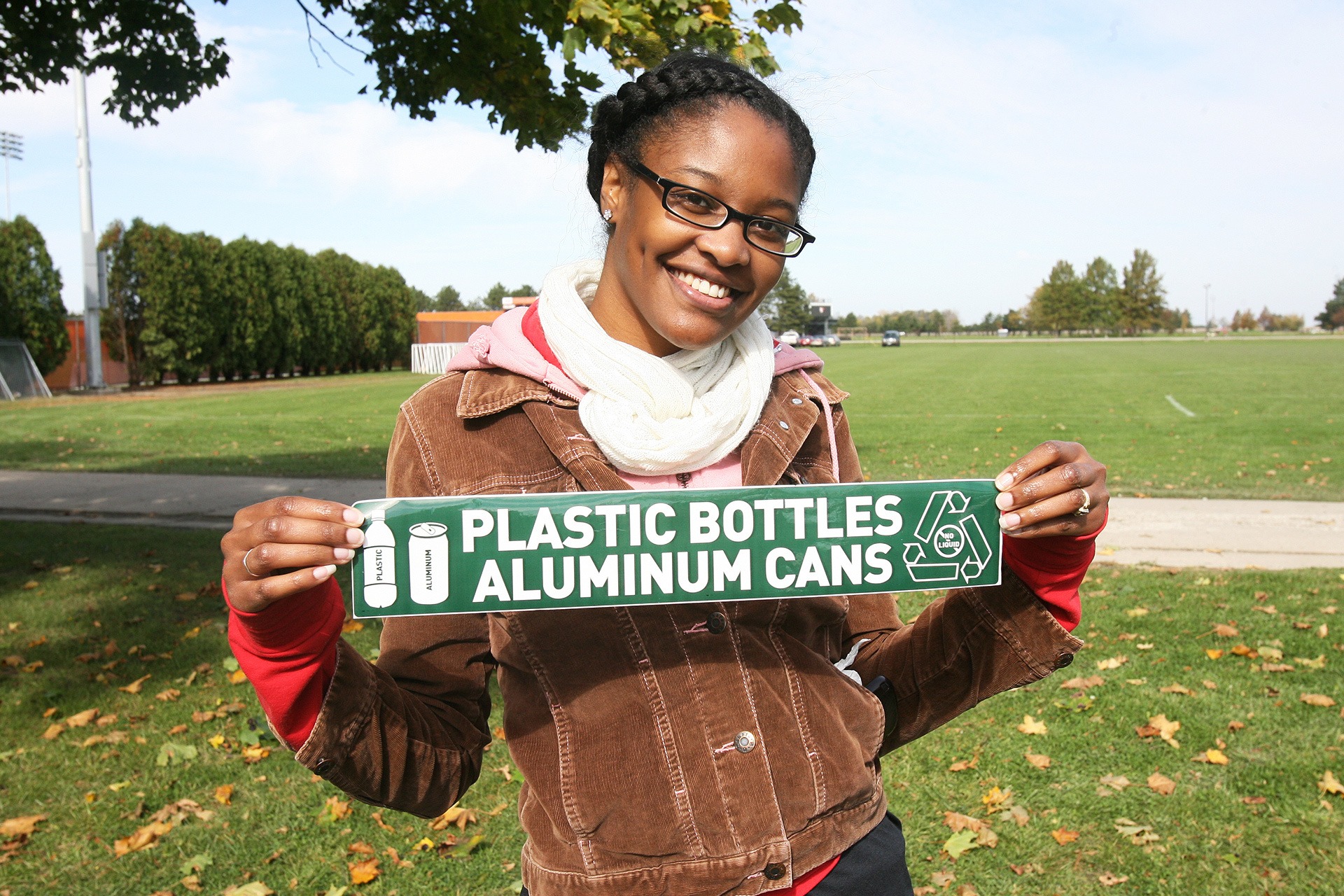 Student holding recycling sign