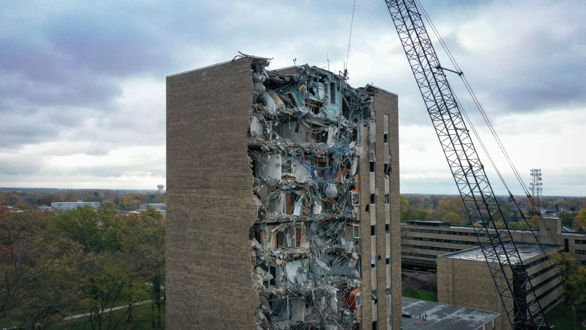 drone photo of the top of the administration building with significant damage to the front of the building from the demolition process