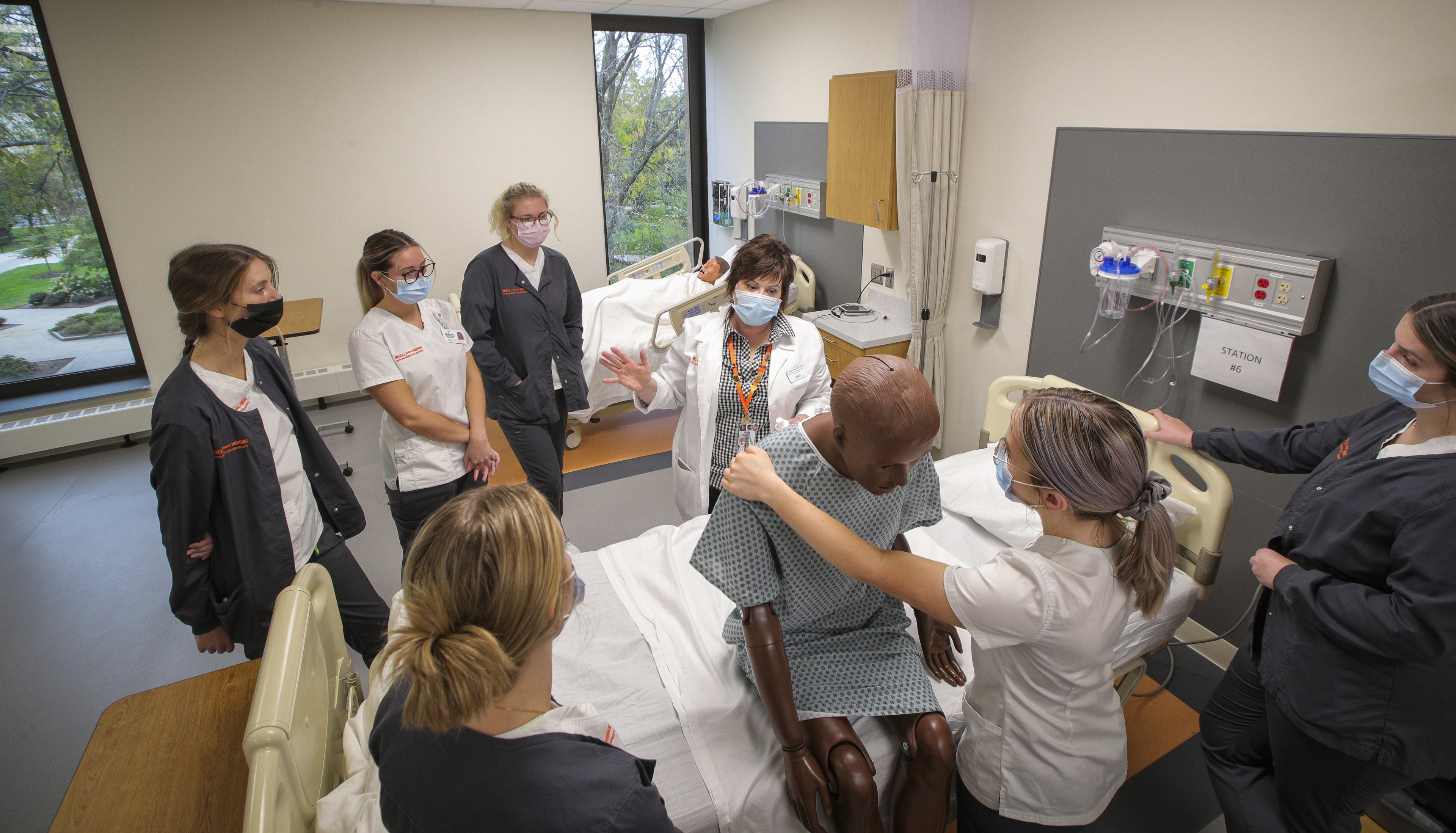 Dr. Annette Oberhaus, assistant professor and Skills Lab coordinator, works with nursing students on various techniques.