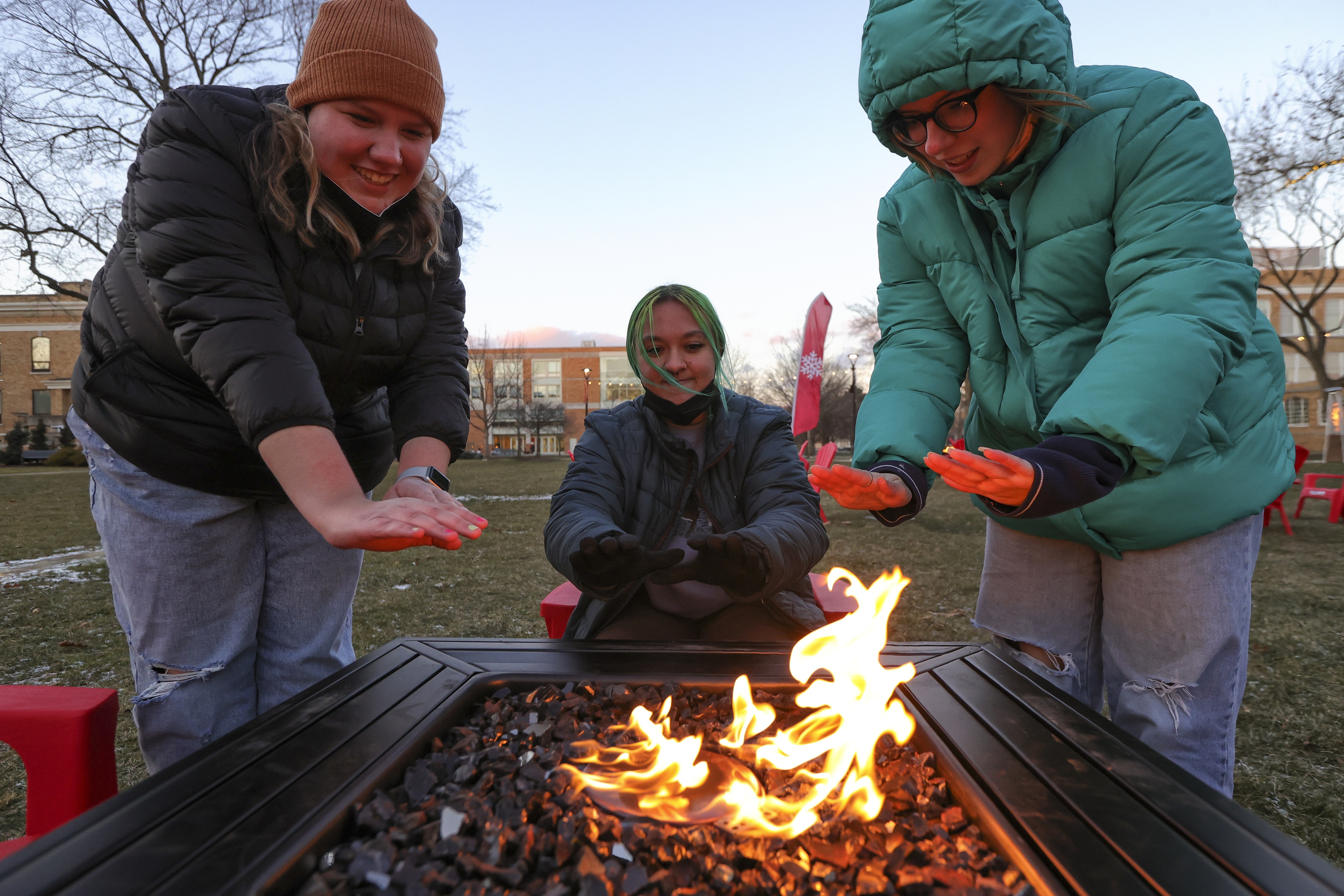 Students warming up by the fire at Winter Wonderland 2022