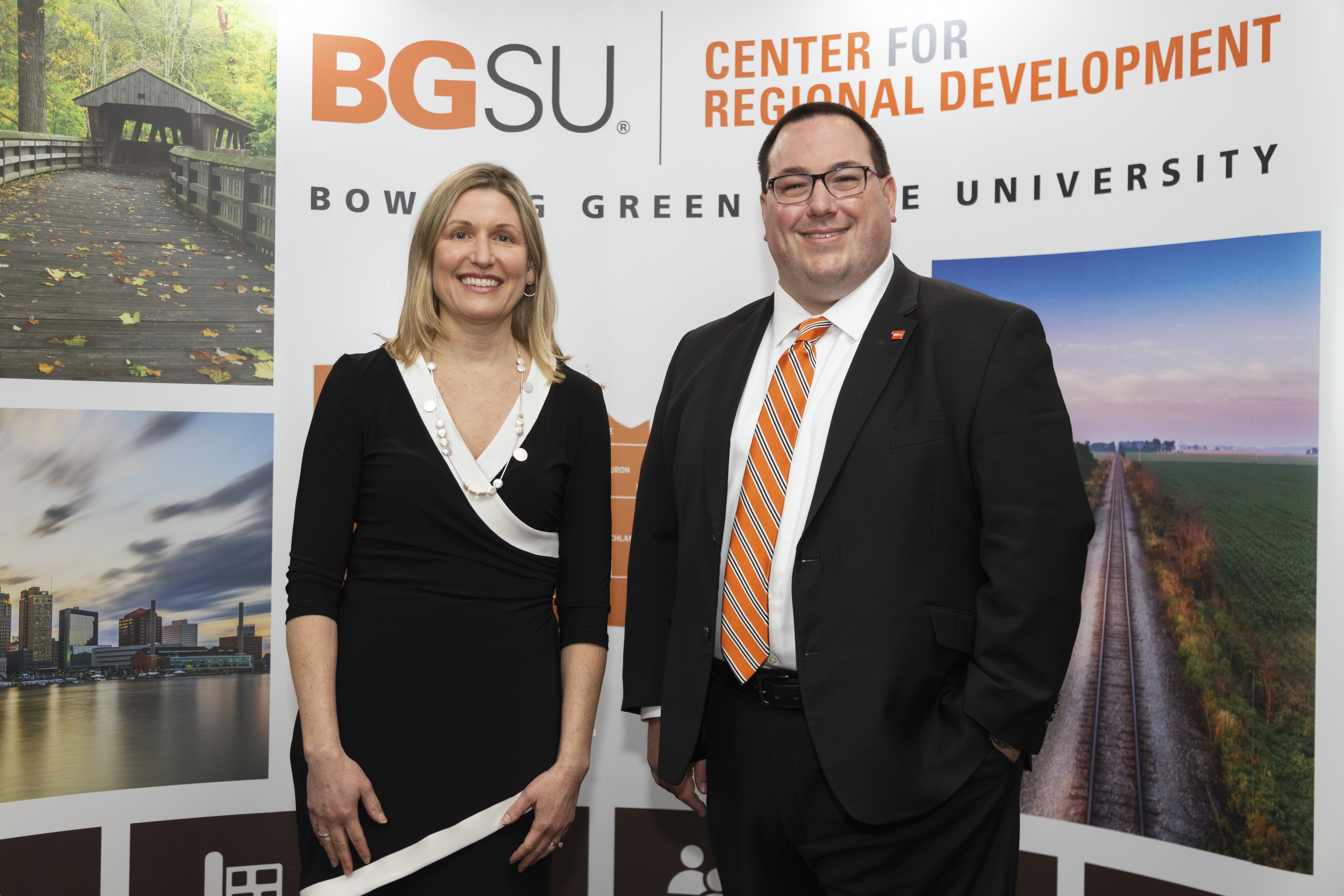 Jennifer Vey and Dr. Russell Mills posed in front of BGSU Center of Regional Development backdrop at the 20th Annual State of Region Conference.