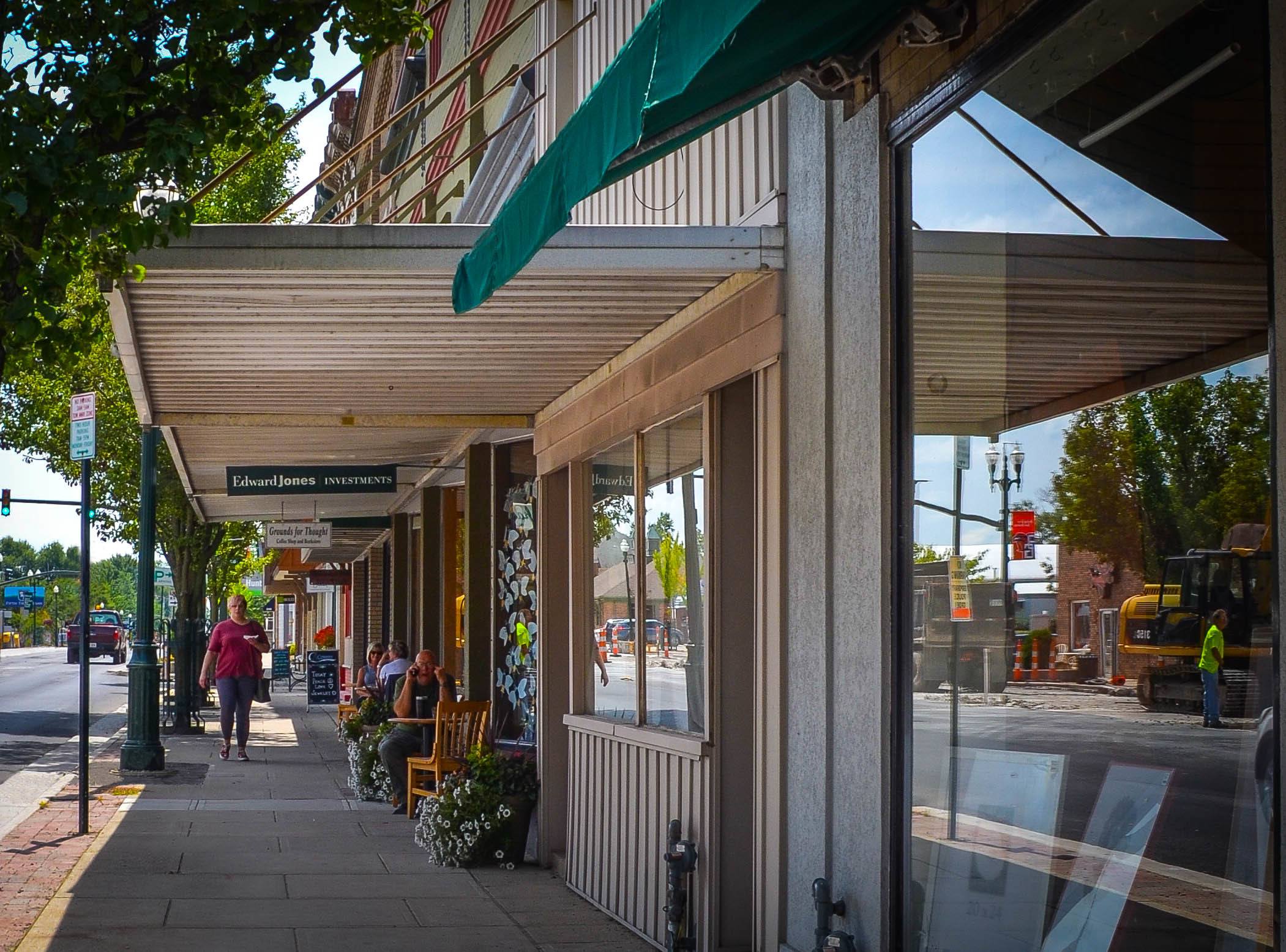 Woman walking through downtown Bowling Green strip