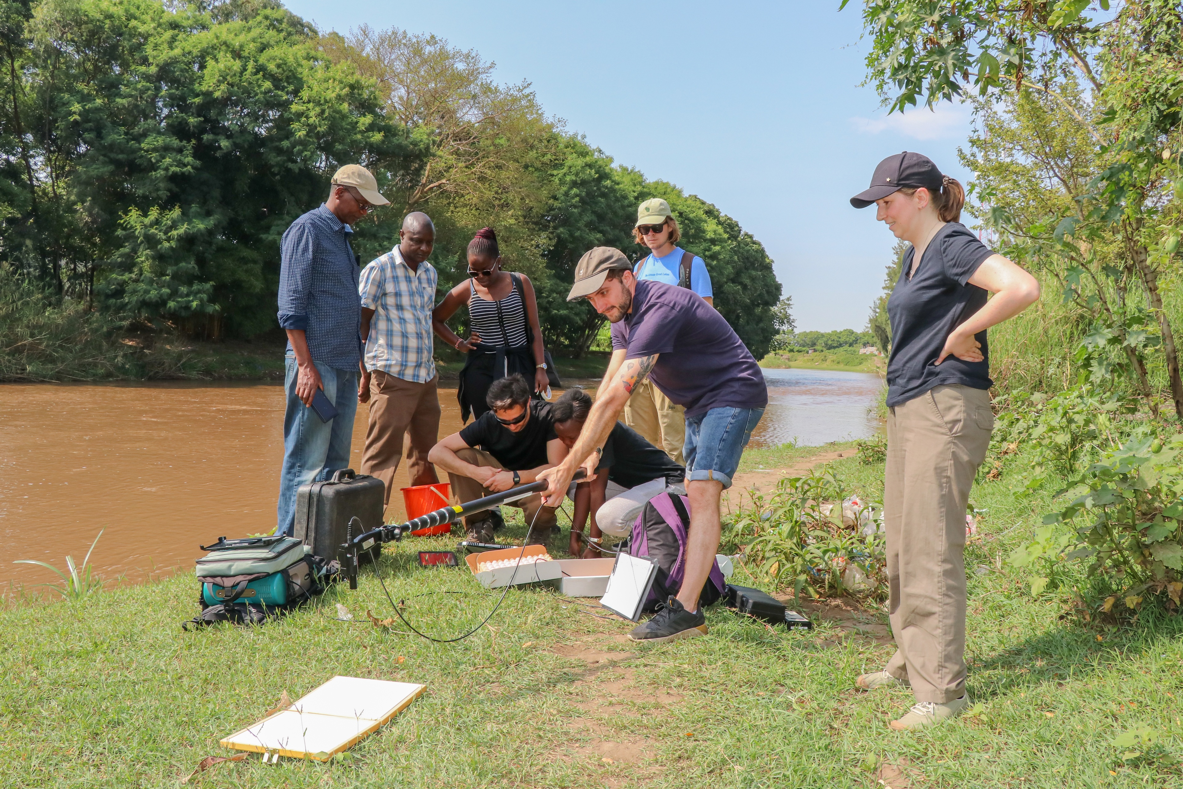 Group of researchers next to a river