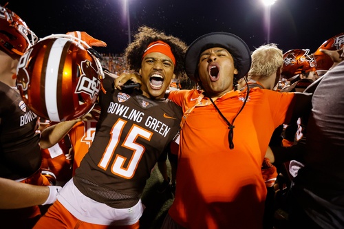 A football player and a fan cheer    