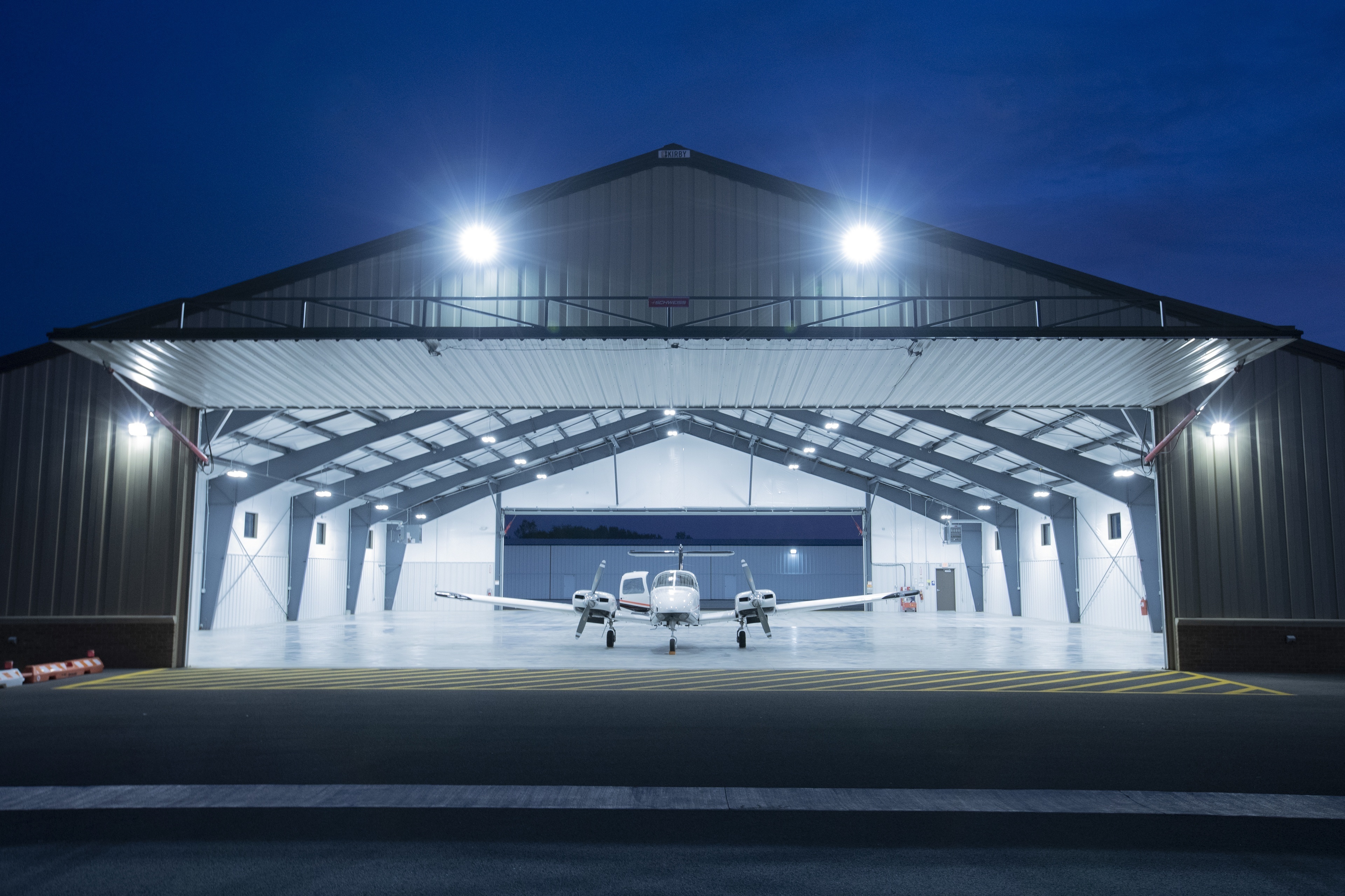 Plane sitting in hanger at night