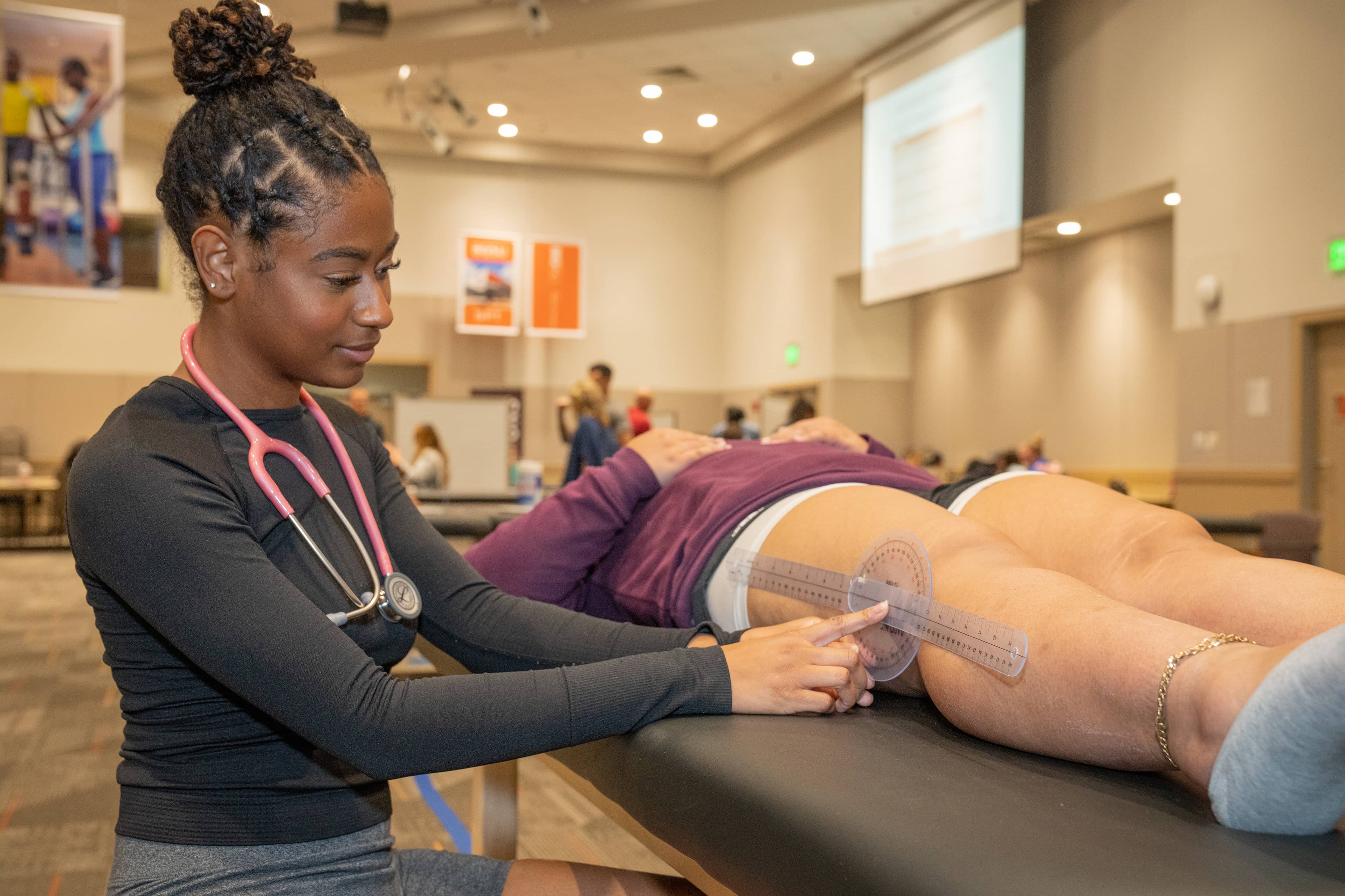 A member of the first cohort of the new DPT program at BGSU, Mekayla Abrahams takes a knee extension measurement during the recent in-person lab immersions on campus