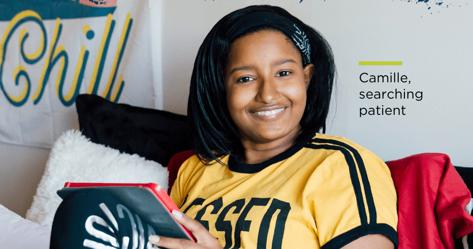 A girl smiling and holding a book